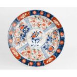 A 19th century Chinese dish, depicting jardinere and flowers to the central roundel, together with a