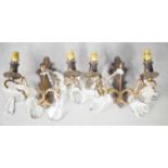 A pair of French wall lights, with twin branches adorned with cut glass drops. * Please note that