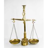 A set of antique brass Librasco scales, the central column with bull finial holding the scale