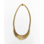 A 9ct gold Egyptian style necklace, composed of graduated segments, 32.8g.