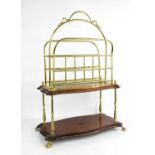 A two tier mahogany brass magazine / letter rack rasied on claw feet60cm high