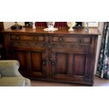 An Old Charm sideboard with two drawers and two cupboards together with an oak dining trestle