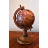 An Italian miniature globe on oak stand