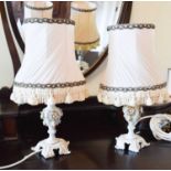 A pair of vintage onyx table lamps, together with a pair of ceramic floral examples.