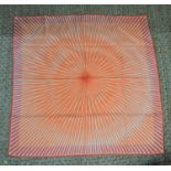 A vintage Hermes silk scarf in a orange starburst pattern