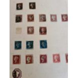 A selection of stamp albums containing worldwide and commonwealth examples, and a page including