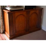 A Victorian mahogany cabinet, with two arched doors enclosing a shelved interior, 76cm by 117cm by