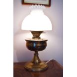 A Victorian brass oil lamp converted to electric with opaque glass shade