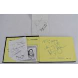 An autograph book containing the signatures of Roger Moore, Billy Connolly, David Carradine, Simon