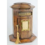 A 20th century oak country house post box, of hexagonal form, hinged front door below a brass letter