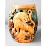 A stoneware glazed Chinese garden seat, modelled in the form of lions amidst trees, and having