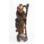 An early 20th century hardwood carved figure of Shou Lao Immortal God of Longevity, 38cm high.