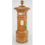 A late Victorian oak country house post box of cylindrical form, the hexagonal top above a hinged