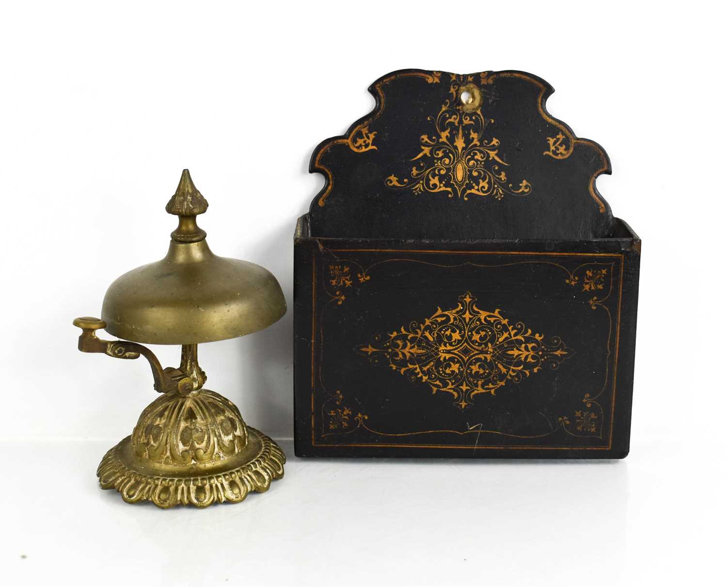 A Victorian black lacquered letter wall rack together with a brass table bell.