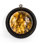 A Victorian glass paperweight depicting the Three Wise Men, in an ebonised roundel frame.