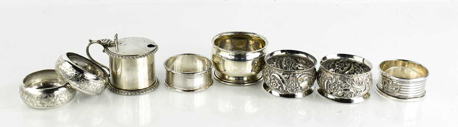 A group of six silver napkin rings, a mustard pot and salt with blue glass liner, 7.3toz total.