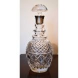 A cut glass decanter with silver collar and original mushroom form stopper, London.