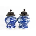 A pair of Chinese blue and white vase and covers, the body depicting prunus blossom, and having