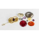 A Victorian pinchbeck and amethyst brooch, a locket of hair within a glazed oval, a citrine, and