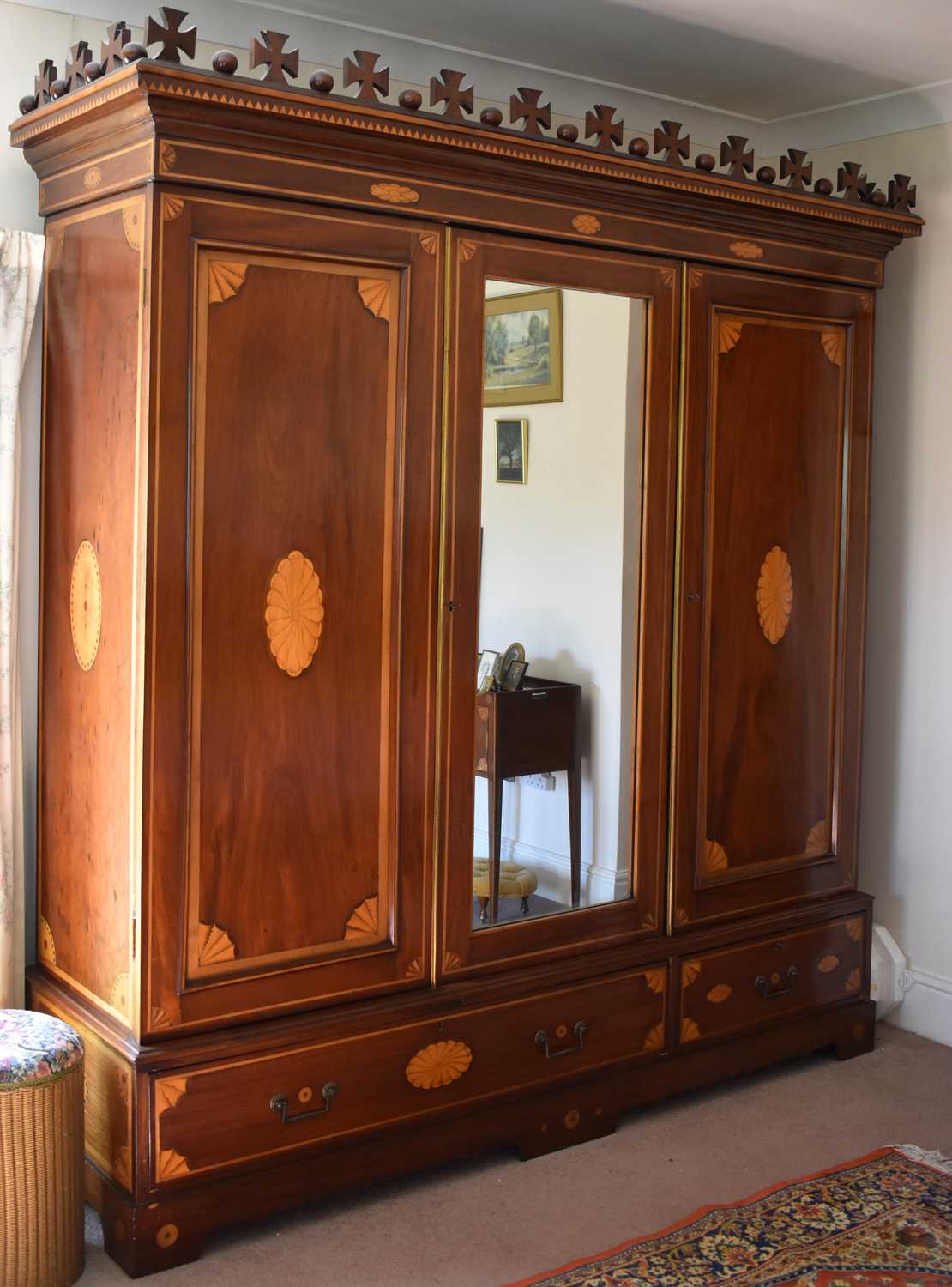 A large 19th century mahogany marquetry inlaid wardrobe with central mirror flanked by two doors