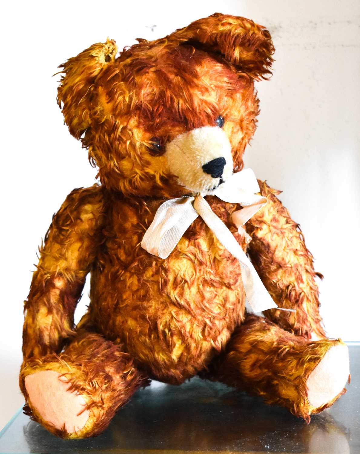 A vintage growler teddy bear in red and yellow, 35cm high