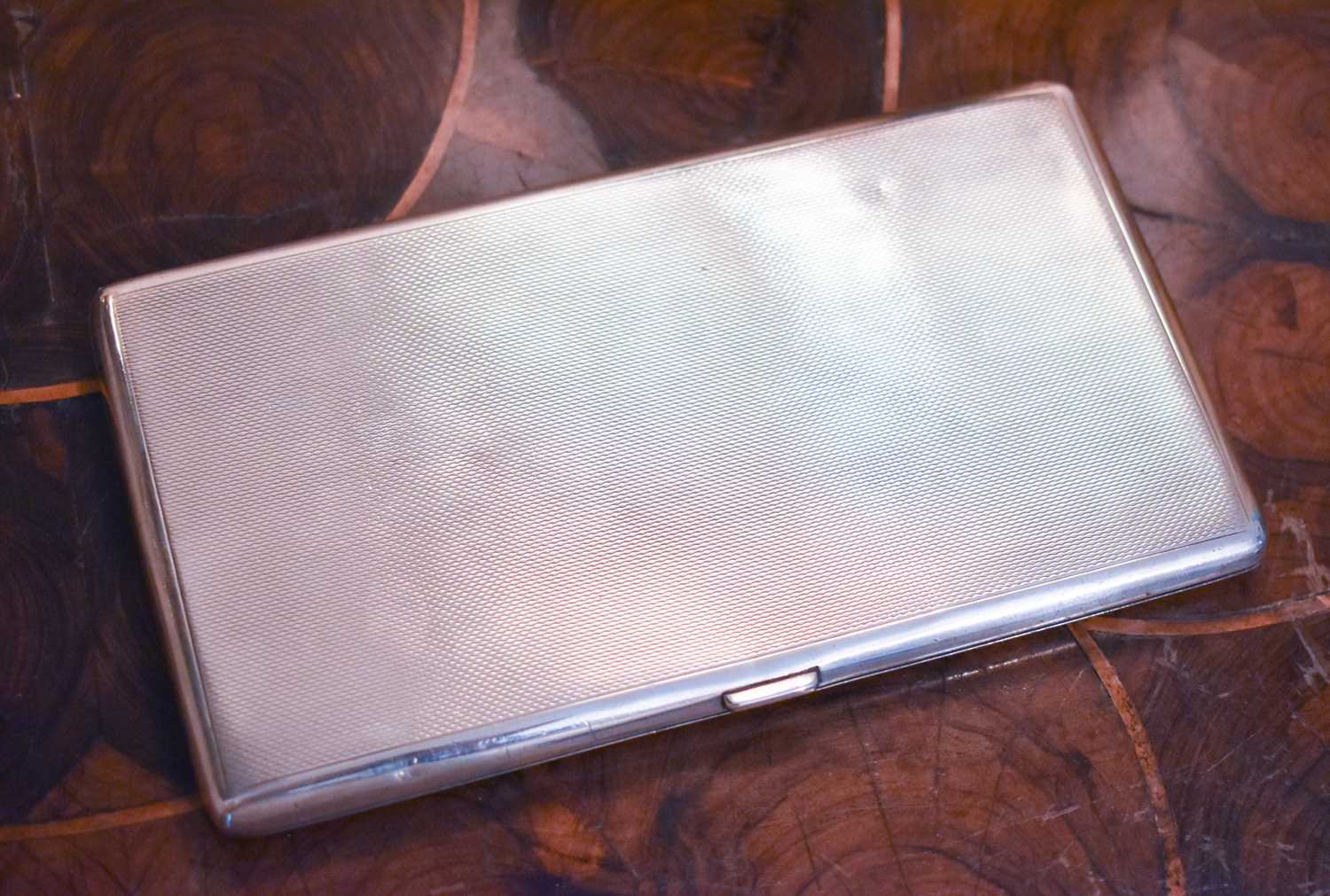 A silver cigarette case, machine engraved and monogrammed, Birmingham, 1.91toz.