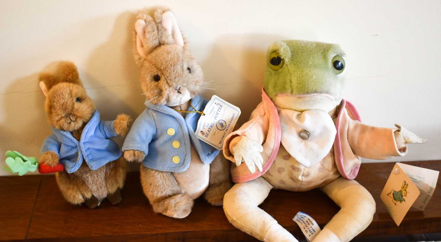 Three Beatrix Potter Peter Rabbit soft toys including Jeremy Fisher and two Peter Rabbits