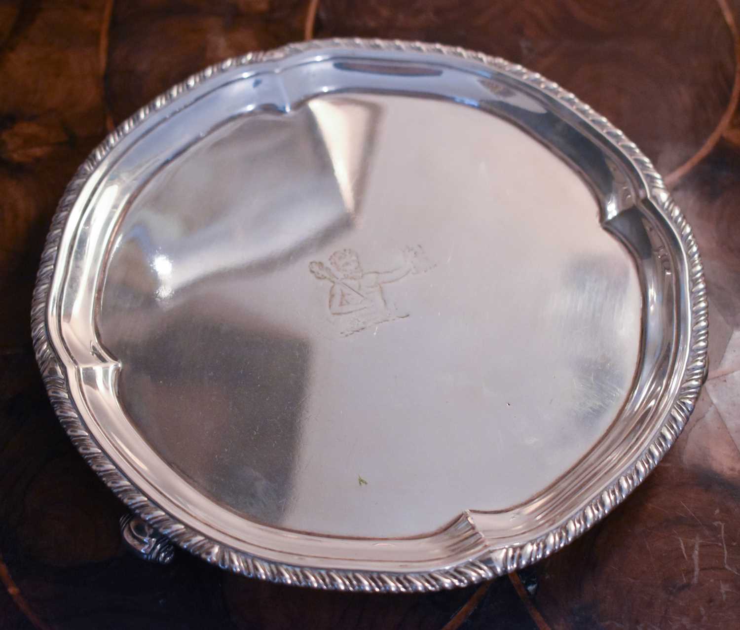 A small silver salver, engraved with man holding boar head, London 1899, 10.89toz.