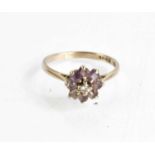 An 18ct white gold, amethyst and diamond flowerhead ring, size O, 2.9g.