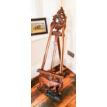 A Victorian style carved mahogany picture stand.