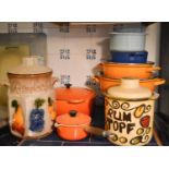 A group of Le Cruset pans, some with lids, together with two West German pots.