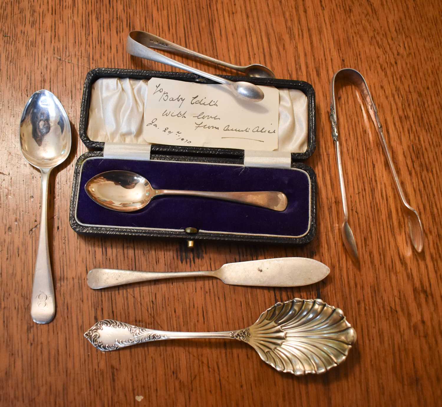 A silver christening spoon in the original presentation box together with a a pair of silver sugar