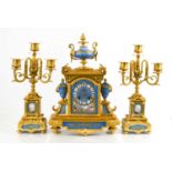A gilt ormolou and porcelain Sevres style mantle clock and matching candleabra.