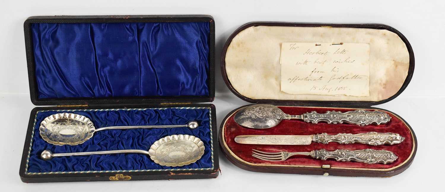 A silver handled christening set and twin jame spoons.