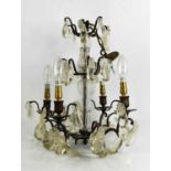 A French brass and glass clad pear drop chandelier, with four branches, circa 1920. * Please note