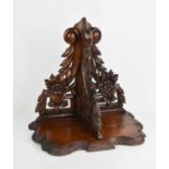 A 19th century carved oak wall bracket / sconce, decorated with carved scrollwork and flowers,