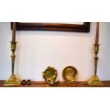 A quantity of brass ware to include a pair of Regency style candlesticks, ashtrays and a fish form