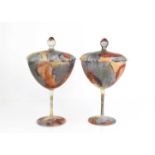 A pair of 20th century painted glass goblets and covers, painted throughout in Impressionist style