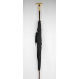 An Edwaridan umbrella with bamboo handle bearing yellow metal collars.Condition report: Fair overall