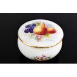 A Royal Worcester box and cover, the lid painted with fruit and flowers by M Hawker, 3ins diameter.