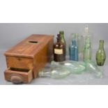 A wooden 20th century and later drawer till with bell, together with various vintage bottles