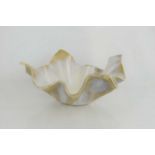 A Studio Pottery handkerchief bowl, of undulating form with cream slip glaze on buff ground, the