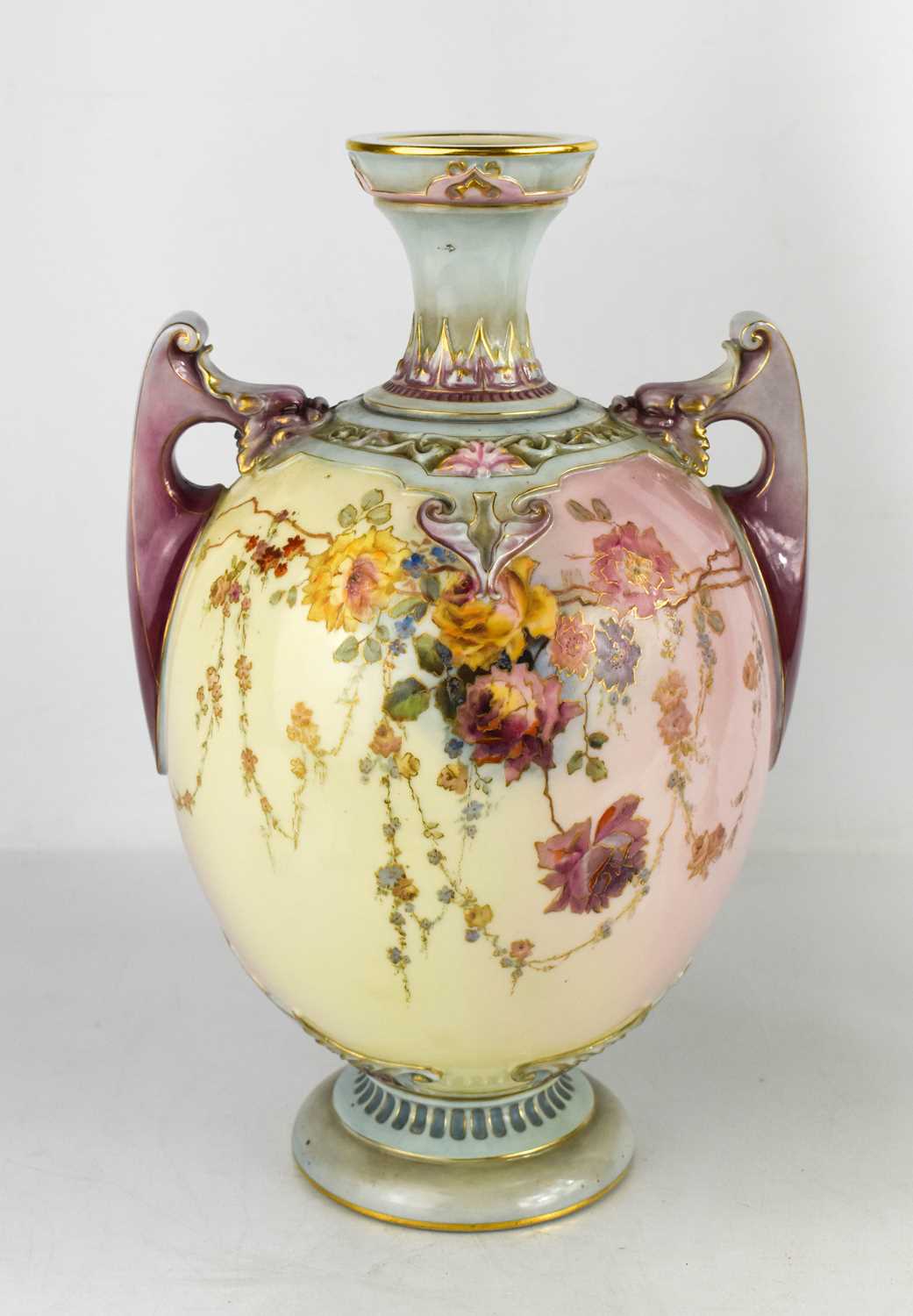 A Royal Worcester vase, painted with flowers to a cream and purple ground, with twin purple