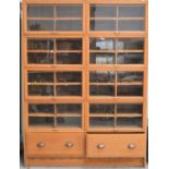 A large Haberdashery shop display cabinet with lift up doors which slide back and open up to