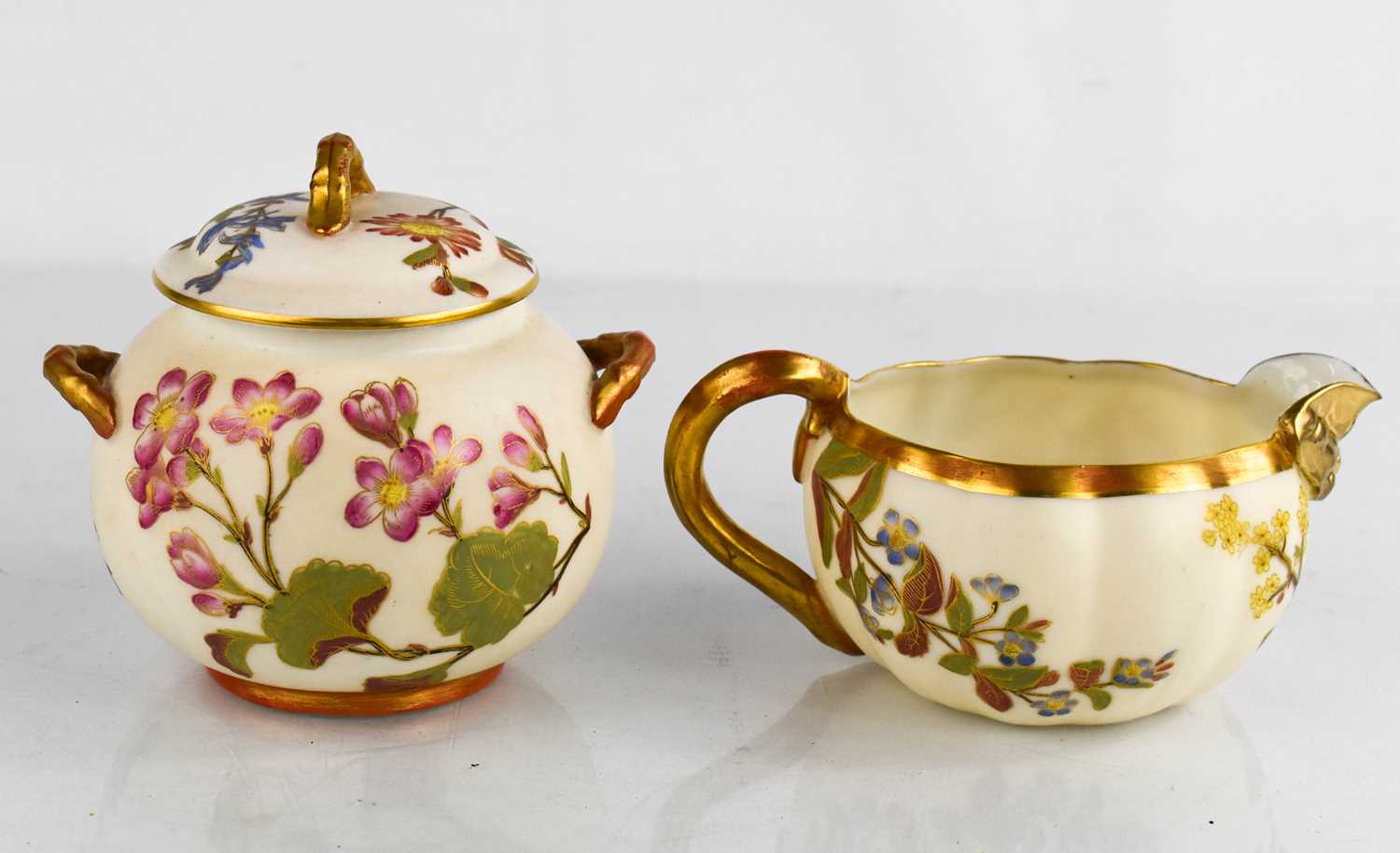 A ROyal Worcester gilded ivory ground jug, painted with flowers, date code 1888, 3 ins high,