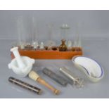 A group of vintage medical and apothercary equipment to include glass measures, pestle and mortar
