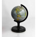 A miniature vintage metal table globe, 20cm high.