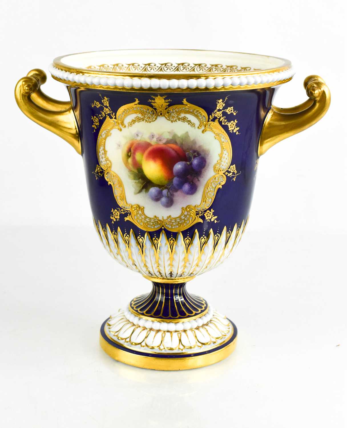 A Royal Worcester campana pedestal vase, painted by R Seabright with a deep blue ground, with twin