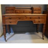 A 19th century Edwards & Roberts mahogany writing desk, the upper section with spindle turned