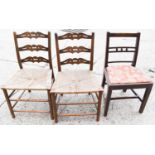 Two early 19th century ladder back chairs with rush seats together with an Edwardian upholstered